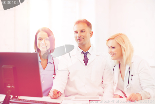 Image of doctors looking at computer on meeting
