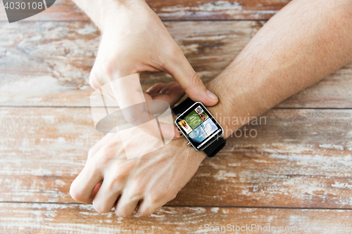 Image of close up of male hands setting smart watch