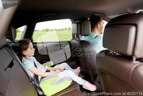 Image of family with child in safety seat driving car