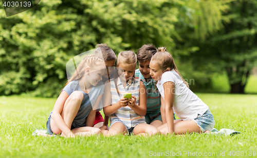 Image of kids or friends with smartphone in summer park