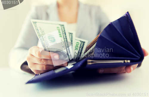 Image of close up of woman hands with wallet and money