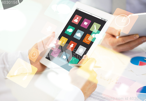 Image of close up of hands with menu icons on tablet pc