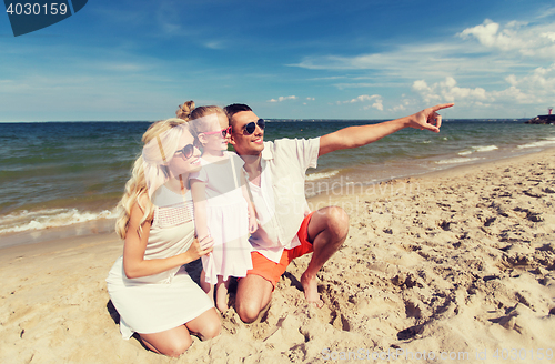 Image of happy family in sunglasses on summer beach