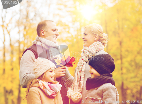 Image of happy family in autumn park