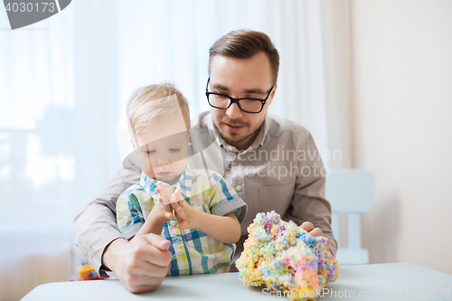 Image of father and son playing with ball clay at home