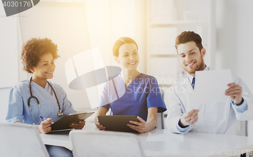 Image of group of happy doctors meeting at hospital office
