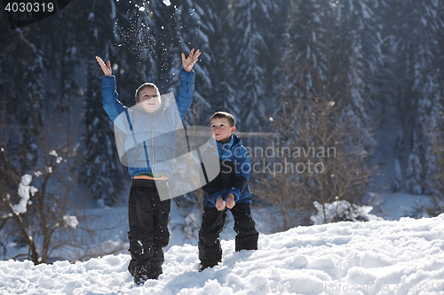 Image of kids playing with  fresh snow