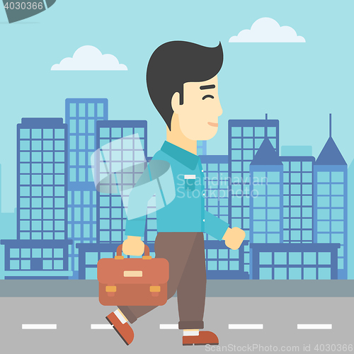 Image of Successful businessman walking with briefcase.