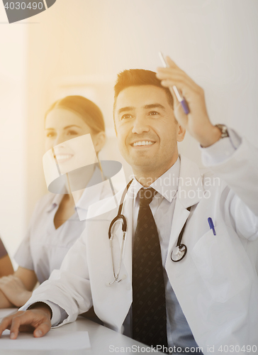 Image of group of happy doctors on conference at hospital