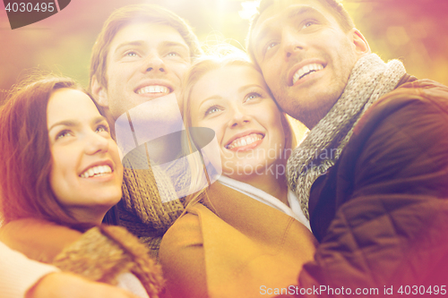 Image of group of friends having fun in autumn park