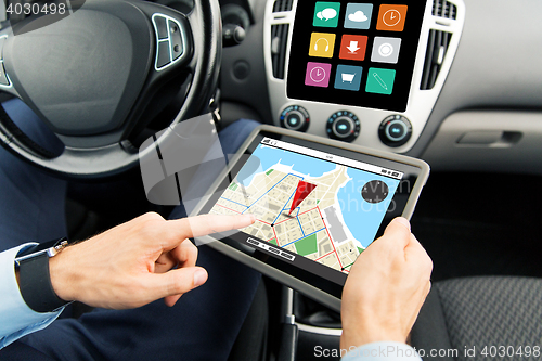 Image of close up of man with tablet pc in car