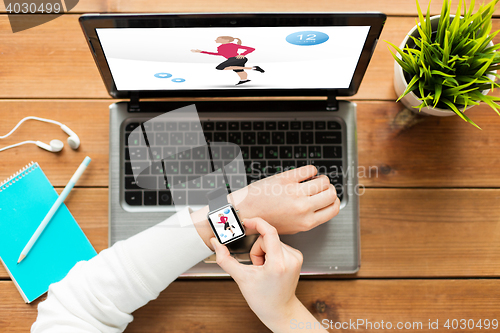 Image of close up of woman with smart watch and laptop