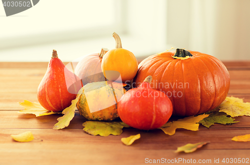 Image of close up of pumpkins on wooden table at home