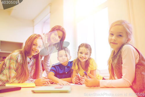 Image of group of school kids writing test in classroom