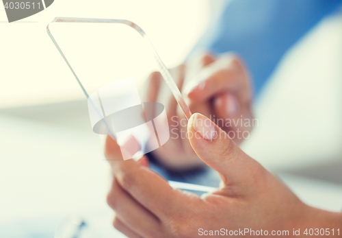 Image of close up of woman with transparent smartphone