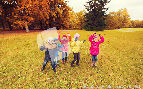 Image of group of happy children having fun in autumn park