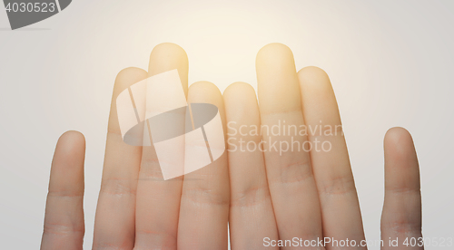 Image of close up of hands showing eight fingers