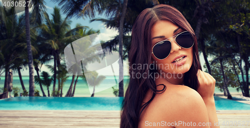 Image of young woman with sunglasses on beach