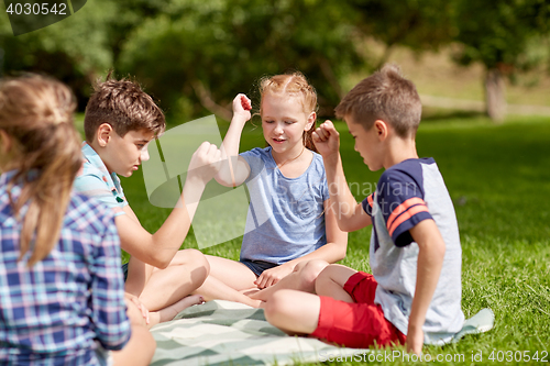 Image of happy kids playing rock-paper-scissors game