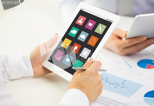 Image of close up of hands with menu icons on tablet pc
