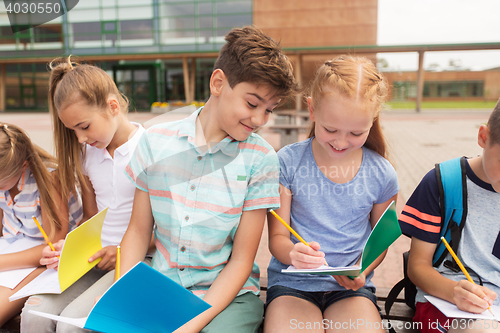 Image of group of happy elementary school students outdoors