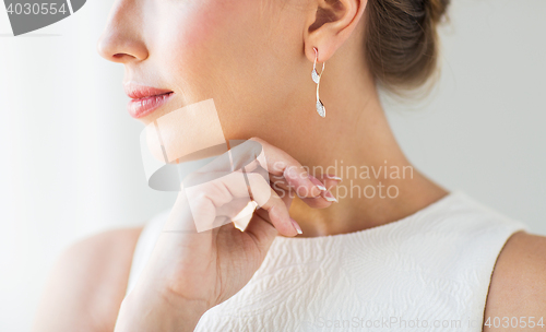 Image of close up of beautiful woman face with gold earring