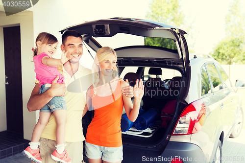 Image of happy family with hatchback car at home parking