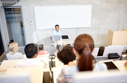 Image of group of students and teacher at lecture