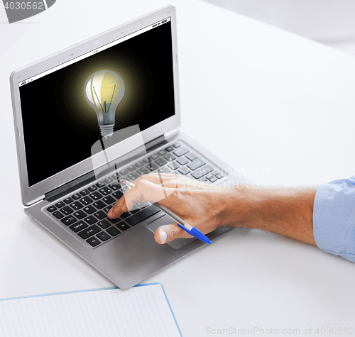 Image of businessman with laptop computer working at office