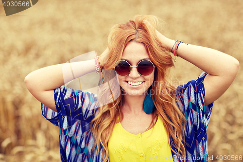 Image of smiling young redhead hippie woman outdoors