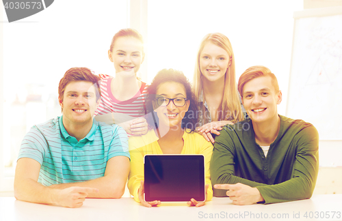 Image of smiling students showing tablet pc blank screen