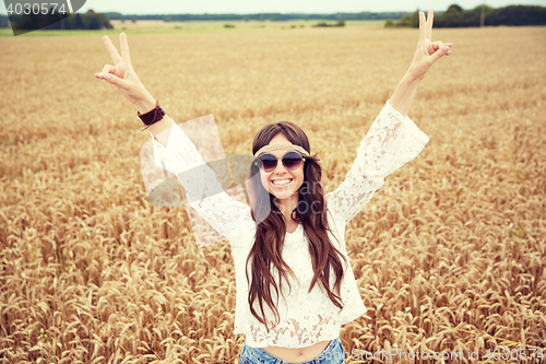 Image of smiling young hippie woman on cereal field