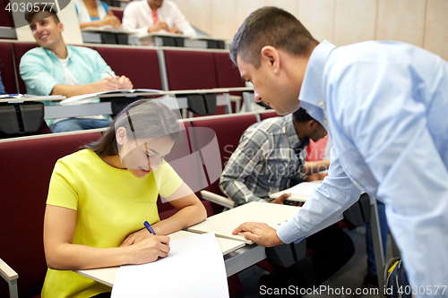 Image of group of students and teacher with notebook