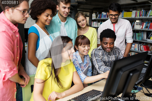 Image of international students with computers at library