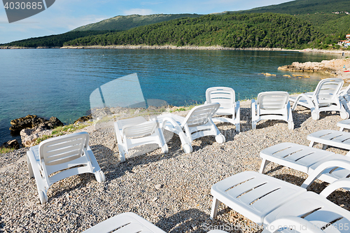 Image of Pebble beach with chaise-longues in Istria