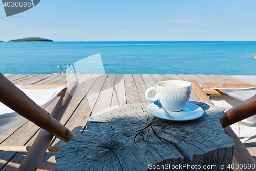 Image of Wooden floor with chaise-longues and coffee