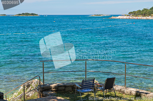 Image of Rocky beach with two chairs in Istria