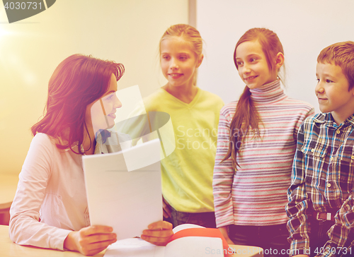 Image of group of school kids with teacher in classroom