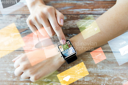 Image of close up of female hands with news on smart watch