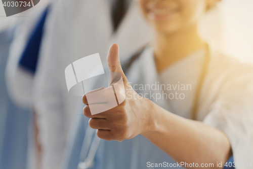 Image of close up of doctor or nurse showing thumbs 