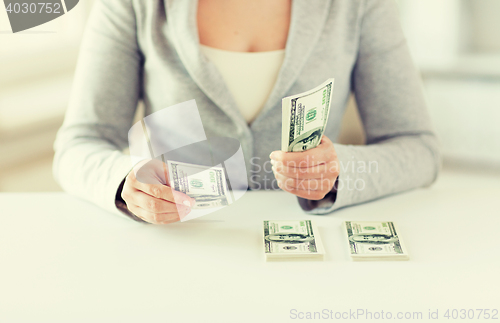 Image of close up of woman hands counting us dollar money