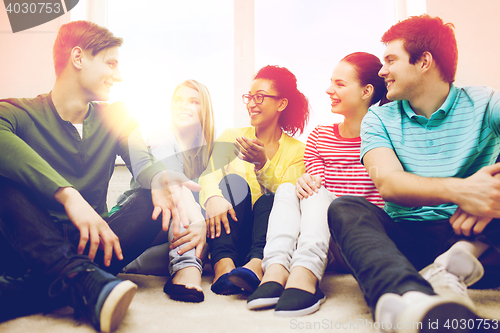 Image of five smiling teenagers having fun at home