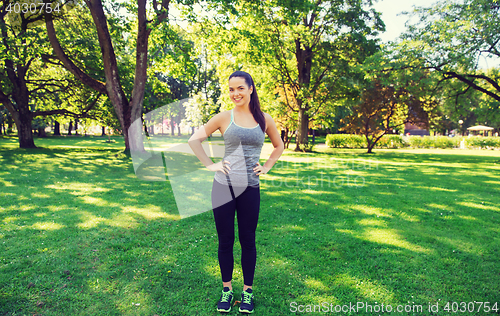 Image of happy young woman exercising outdoors