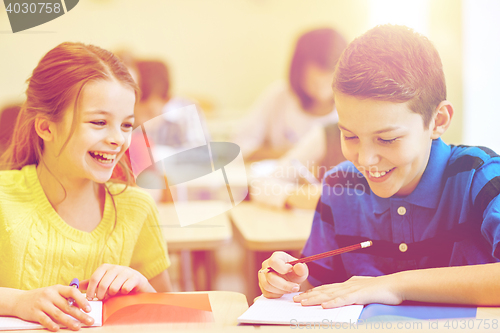 Image of group of school kids writing test in classroom