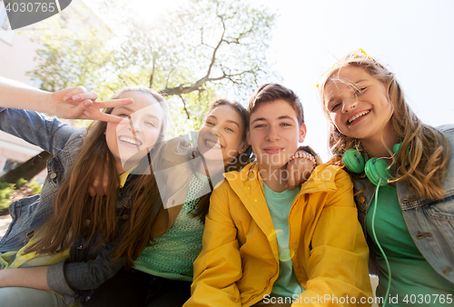 Image of happy teenage students or friends having fun