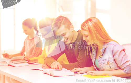 Image of students with textbooks and books at school