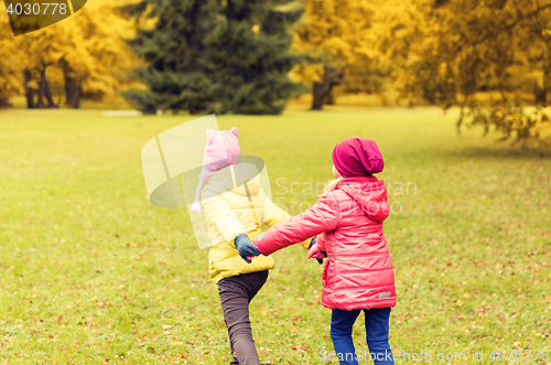 Image of happy little girls running outdoors