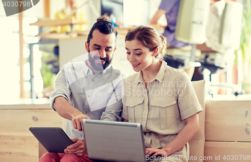 Image of creative team with tablet pc and laptop in office