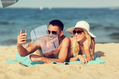 Image of happy couple in swimwear walking on summer beach