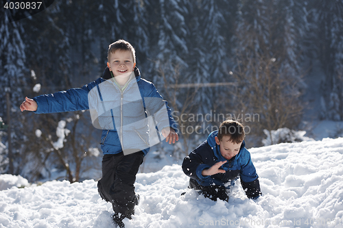 Image of kids playing with  fresh snow